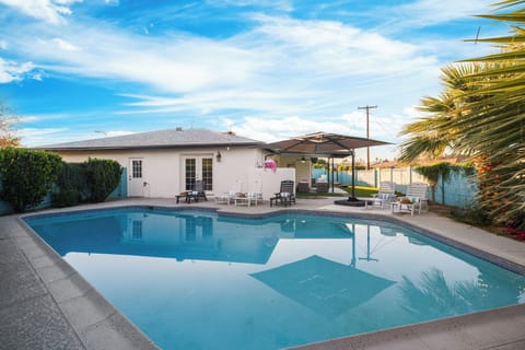 Private Scottsdale backyard with heated pool, loungers, and shaded outdoor living.