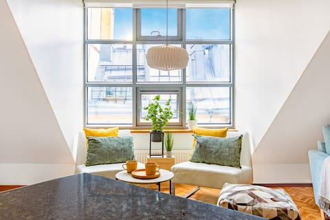 You settle into the leather chairs as natural light fills this open, calming living room. The clean lines, warm textures, and bright atmosphere create a space where you instantly unwind.