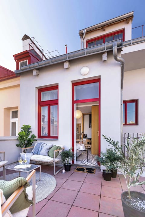 A spacious private terrace with comfortable seating, perfect for enjoying fresh air, morning coffee, or a quiet evening outdoors. Directly accessible from the apartment, it offers a relaxing extension of your living space.