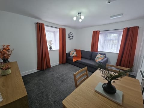 Living Room With Dinning Area, TV and SofaBed