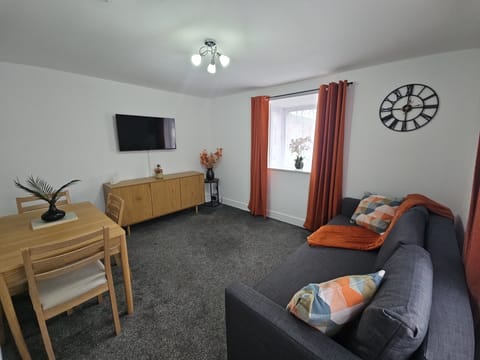 Living Room With Dinning Area, TV and SofaBed