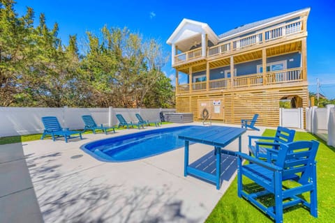 Dive into your private pool oasis with vibrant blue outdoor furniture, perfect for sunny afternoon relaxation and poolside dining.
