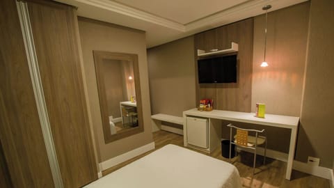 Refresh between outings with a handy desk, minibar, and TV.