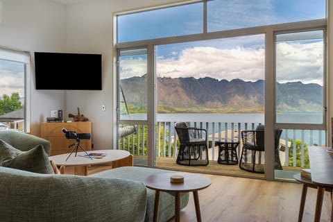Living room with sweeping lake and mountain views, opening directly onto the balcony.
