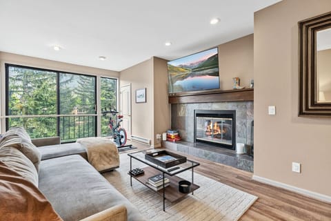 Spacious living room with fireplace, smart TV, and gorgeous views