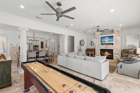 Unwind in your spacious living area where a crackling fireplace meets modern comfort, complete with game table for memorable evenings.