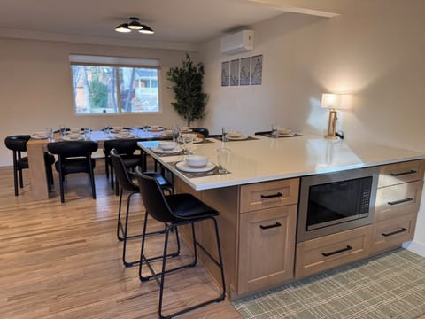 Large dining table comfortably seats 8, paired with the island seating for 5