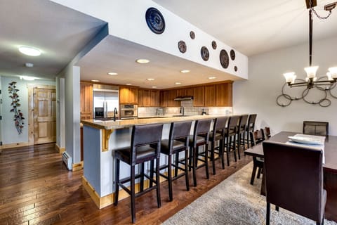 Gather around the stylish dining table and kitchen bar, ideal for meals, conversation, and creating memories in your mountain retreat.