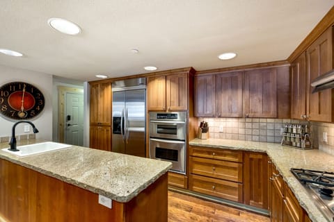 Spacious and inviting kitchen with granite countertops, ideal for preparing meals or entertaining guests in your mountain retreat