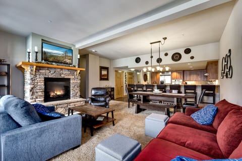 The open floor plan connects the living room to the dining area and modern kitchen, ideal for family gatherings and entertaining.