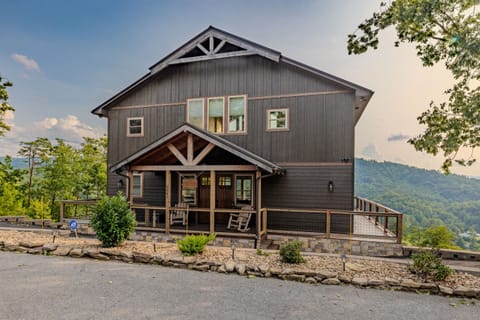 Welcome home! The beautiful cabin exterior with its inviting front porch and rustic charm is the perfect start to your mountain getaway.