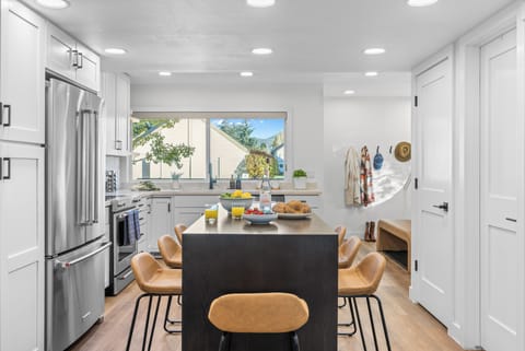 Open-concept kitchen and dining area with island seating.