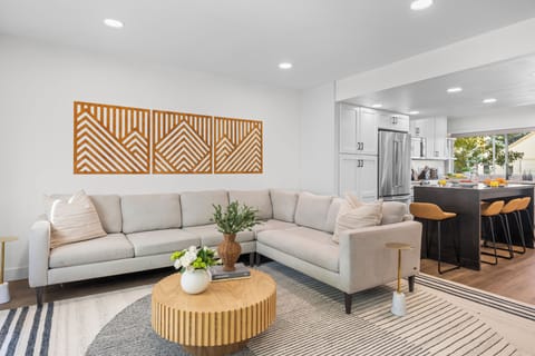 Spacious living area with sectional sofa and coffee table.