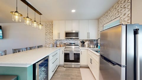 Newly remodeled kitchen with stainless steel appliances and fully stocked essentials.