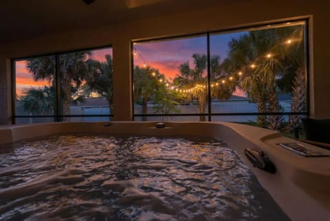 Soak it all in. This private indoor hot tub is your spot to unwind after a day at Flagler Beach. Warm water, bubbling jets, palm trees swaying outside. This is Florida living at its best. Palm Coast vacation home with hot tub.