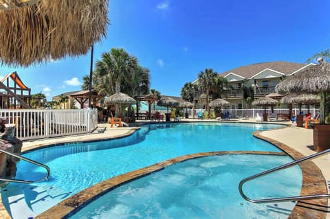 Resort Pool — Freeform Pool, Tiki Umbrellas, Rock Waterfall, Colorful Adirondack Chairs & Palm Trees