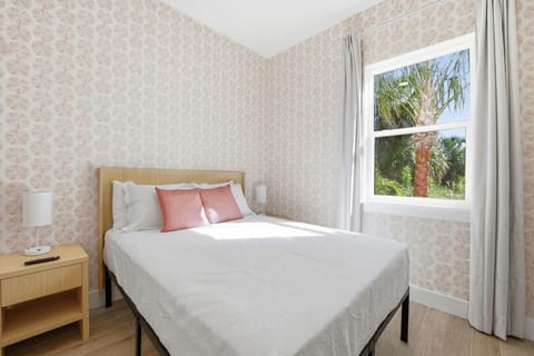 Unwind in a cozy queen bed set in a peaceful, calming room.