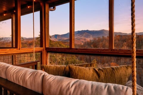 Screened in porch with a daybed swing with amazing views!
