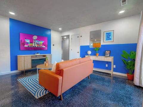 Spacious open living room with comfy seating and big-screen TV for game day