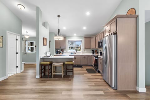 Your spacious kitchen awaits with modern appliances, granite counters, and a breakfast bar perfect for morning coffee or evening conversations.