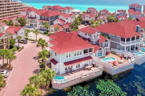 Grits Carlton—your luxury coastal escape that SLEEPS 15! Steps to PRIVATE beach access and includes a FREE golf cart. Enjoy the lakefront deck, HEATED splash pool, outdoor dining, and gorgeous views. The perfect spot for unforgettable beach vacations!