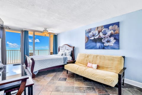 Spacious oceanfront studio featuring a comfortable bed, sleeper sofa, and private balcony with stunning beach views. Perfect for a relaxing beach stay with coastal charm, natural light, and easy access to the shoreline.