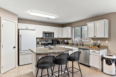 “Fully equipped kitchen with spacious countertops and bar seating—perfect for cooking, snacking, and gathering.”