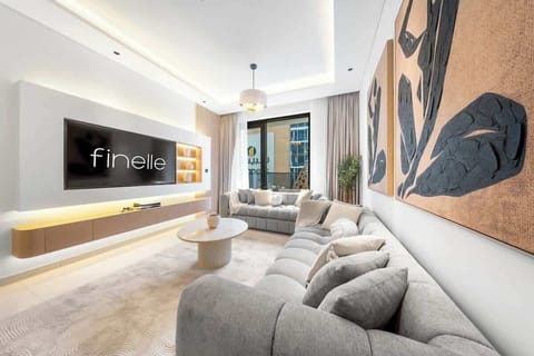 Stylish living area with seating, Smart TV, and balcony views