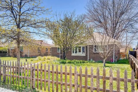 Charming brick bungalow with a classic wood picket fence and mature landscaping. A well-maintained lawn and large trees provide excellent curb appeal for this cozy residential home.
