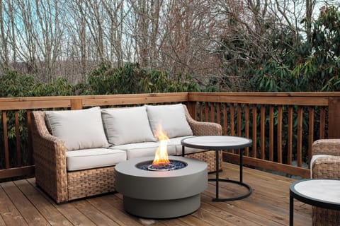 Another inviting deck space with plush seating and a fire feature. Enjoy private outdoor relaxation surrounded by nature's quiet backdrop.