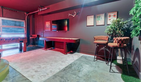 Private speakeasy lounge with shuffleboard, dart board, TV & more — only steps from your door