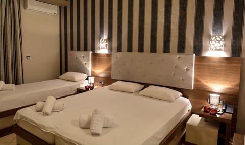 Deluxe Triple Room, Partial Sea View | Premium bedding, minibar, in-room safe, blackout drapes