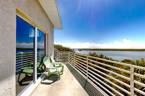 Enjoy a peaceful beach stay from this private waterfront balcony, featuring serene lagoon views, coastal breezes, and outdoor seating—perfect for morning coffee or sunset relaxation during your seaside vacation.