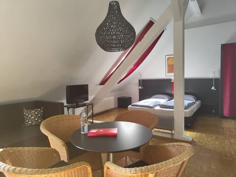 Bright loft studio with bed and dining area in Konstanz
