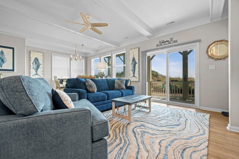 Sink into plush seating while coastal breezes flow through your bright living space, where nautical touches meet comfort.