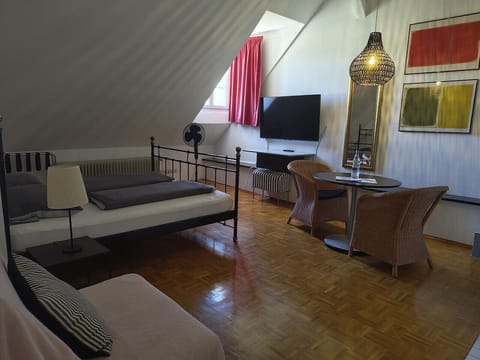 Spacious loft studio with bed and dining area