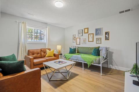 “Bright living room with comfy seating and gallery wall log into your streaming apps on the smart TV or unwind after a day out.”