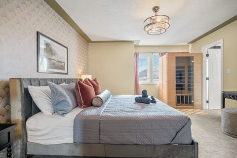 King bed, blackout curtains & chandelier in the Old Hollywood suite. Your private infrared sauna is just steps away through that door.