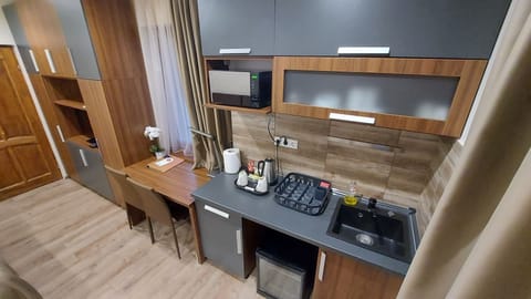 Deluxe Apartment, Non Smoking | Private kitchen | Fridge, coffee/tea maker, electric kettle, highchair