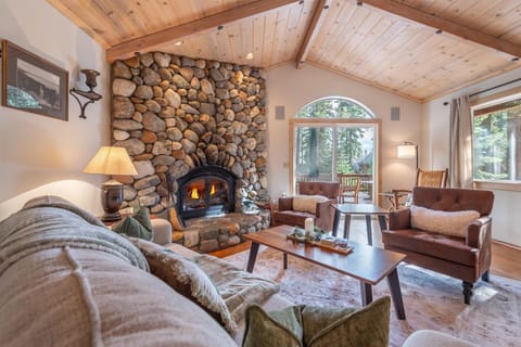 Curl up in this cozy living room, where vaulted wood ceilings and forest views create the perfect mountain retreat for unwinding after your adventures.