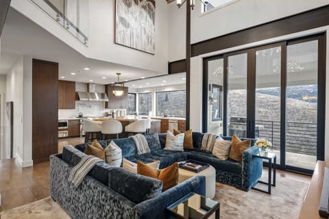Second living room with a u-shaped couch, TV and mountain views