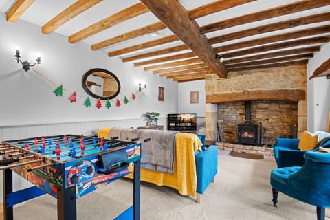 Cosy living room with exposed beams and foosball table