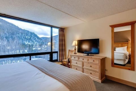 Bathe in natural light while gazing at breathtaking mountain vistas from this serene bedroom, designed for ultimate relaxation and luxury.