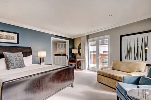 This elegantly appointed suite features a plush king bed and a cozy living area, perfect for unwinding after a day of mountain adventures.