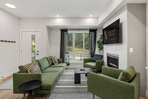 Living room, located on the main floor, with cozy seating options, a gas-lit fireplace and board games.