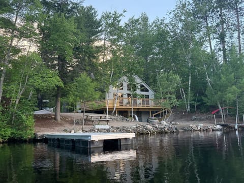 View of camp from the lake showing docks, hammock, water access
