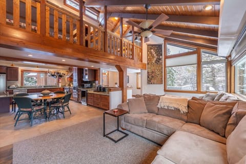 Large Open Great Room (living area, kitchen, dining) with comfortable furnishings, large SmartTV, wood burning fireplace & picture windows with mountain views.