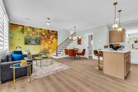 Relax on the plush sofa in this bright, sunlit space, featuring bold golden accents and a warm, inviting atmosphere. Perfect for lounging, reading, or spending quality time with loved ones. 🛋️✨