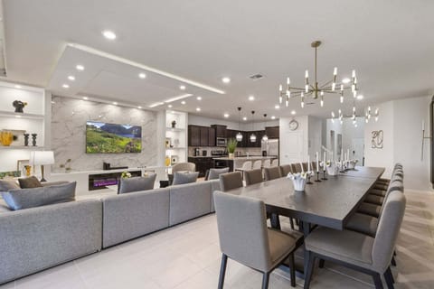 Gather in this beautifully designed living area, complete with a huge sectional sofa, an indoor fireplace, an oversized dining table, and a fully equipped kitchen. Perfect for making memories together.