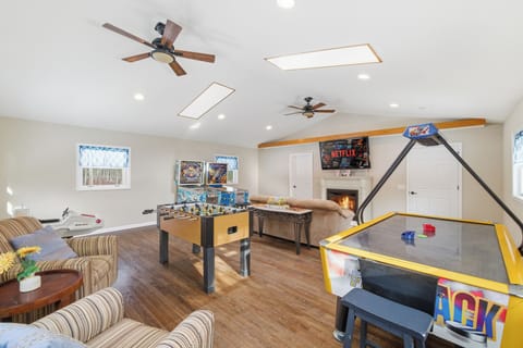 Spacious Poconos game lounge with arcade fun and comfy couches.